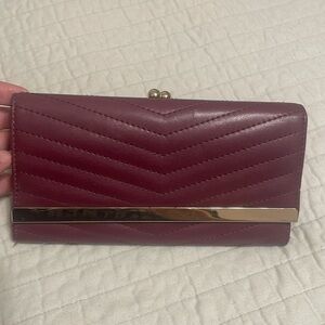 A new day burgundy wallet; in good condition